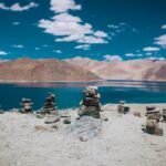 rock formation near calm body of water during daytime